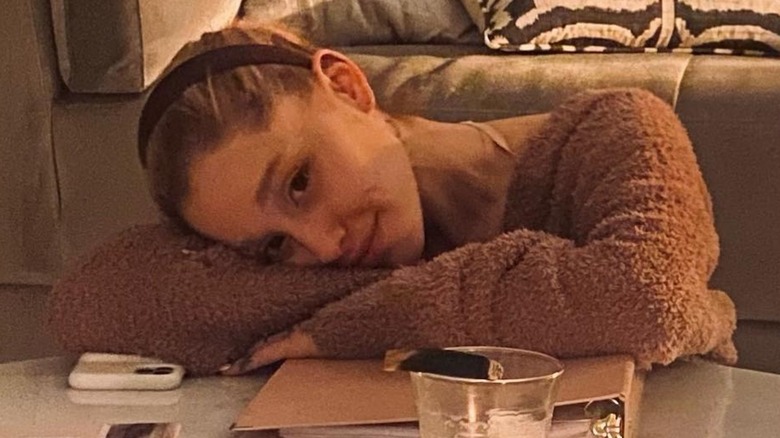 Ariana Grande appuyée sur son bras sans maquillage