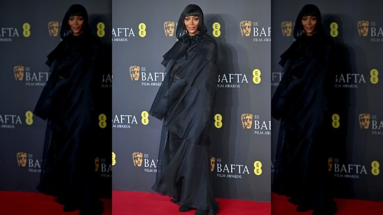 Naomi Campbell portant une cape à capuche aux BAFTA