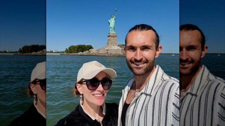 Lotte Verbeek et son mari devant la Statue de la Liberté par une journée ensoleillée
