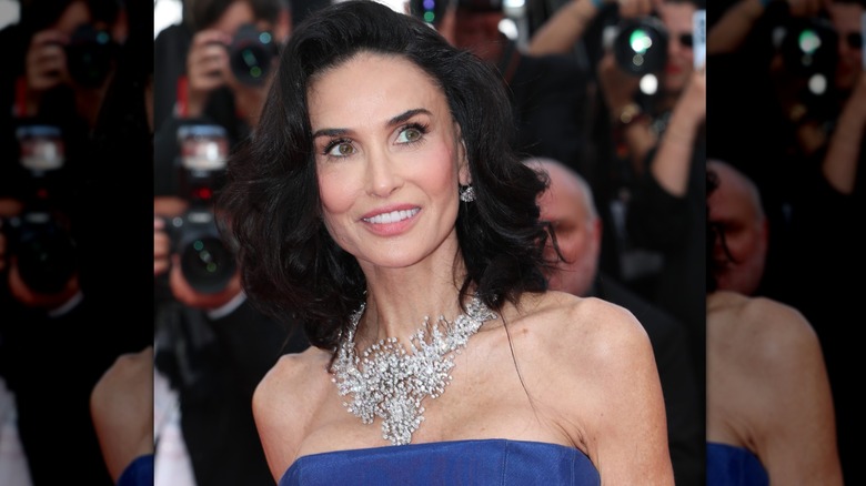 Demi Moore souriant et regardant hors caméra lors d'une première sur le tapis rouge en 2026