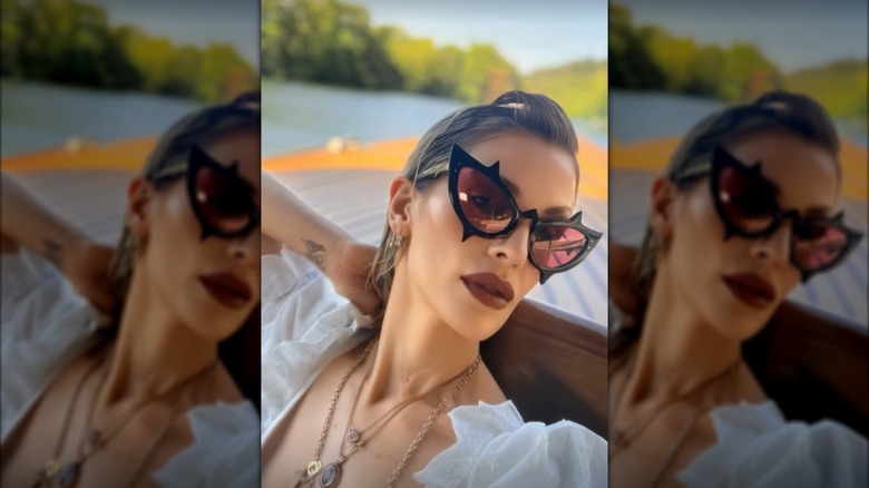 Kelly Osbourne avec du rouge à lèvres marron et des lunettes de soleil œil de chat noires