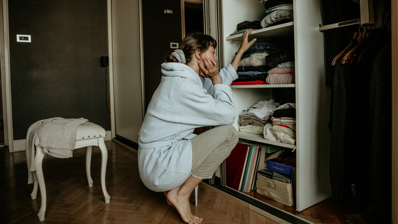 Une femme regardant dans son placard