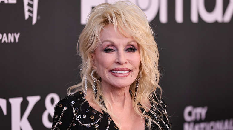 Dolly Parton sourit sur le tapis rouge en 2022