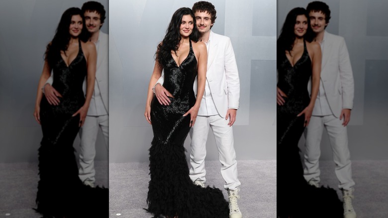Kylie Jenner porte une robe queue de poisson noire et Timothée Chalamet porte un costume entièrement blanc